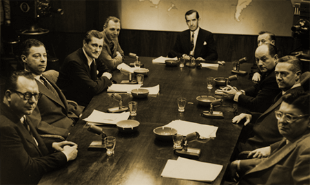 Edward R Murrow presides over a 1955 complement of his 'Murrow's Boys.' (from left, Bill Downs, Daniel Shorr, Eric Sevareid, Richard C Hottelet, Murrow, Robert Pierpont, David Shoenbrun, Howard K. Smith, Alexander Kendrick)